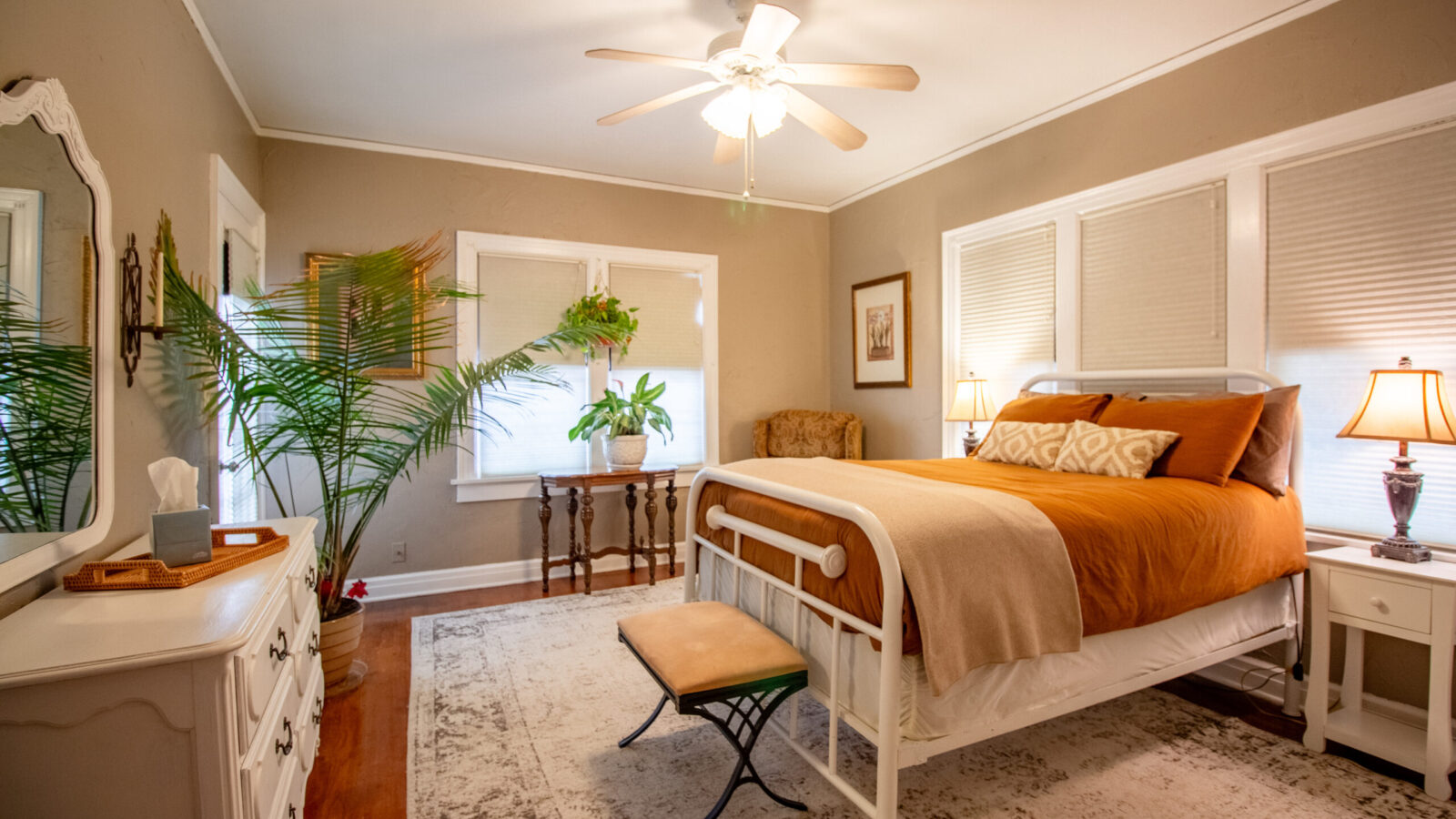 Bedroom one at Vintage Charm OKC with plush bedding and warm lighting