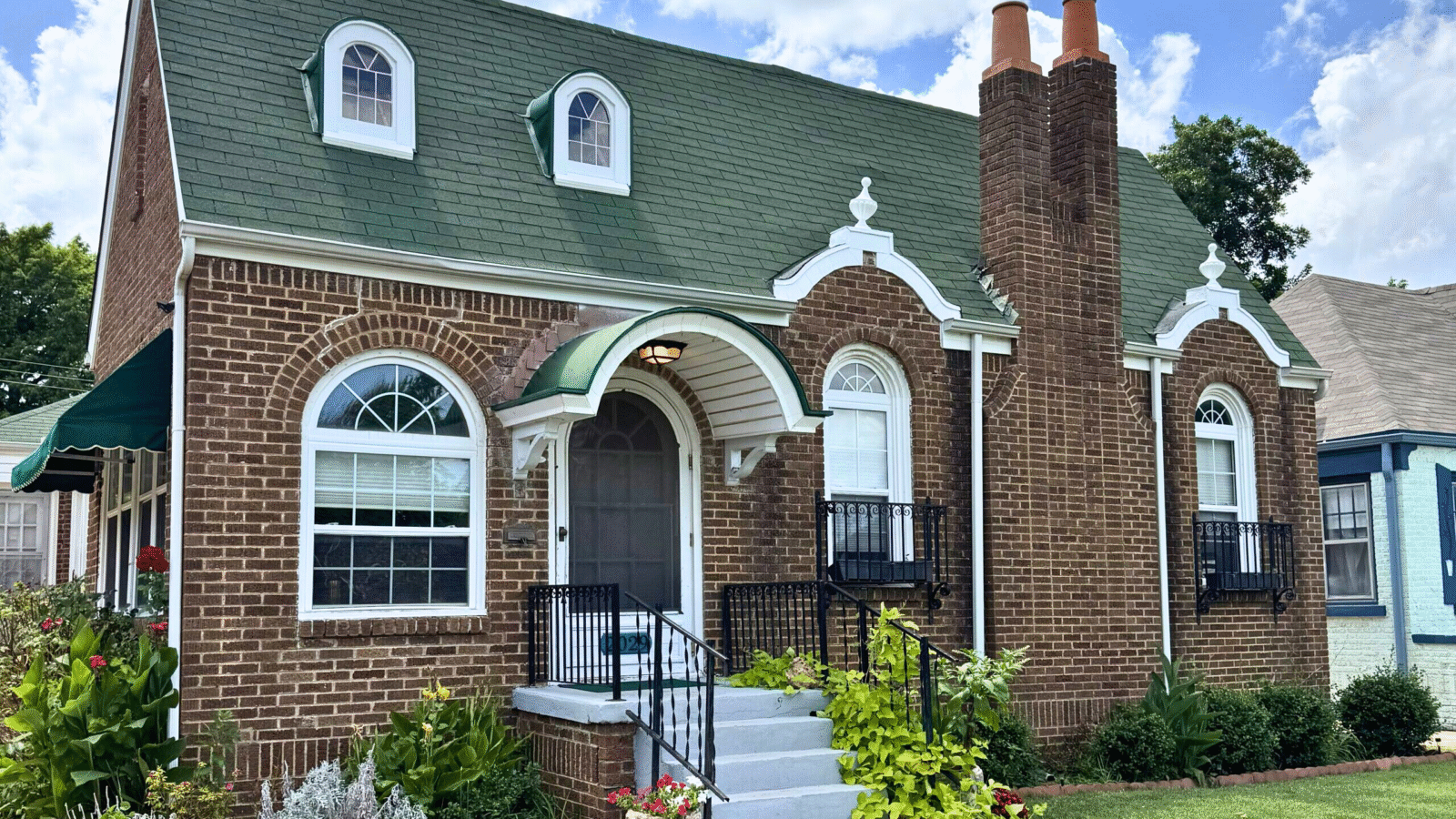 The vintage charm of Gatewood Home starts at the front door with charming architectural detail and pretty landscaping.